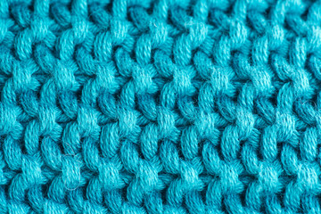 closeup of turquoise knitted wool texture, background
