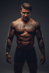 Fototapeta na wymiar Naked muscular tattooed man