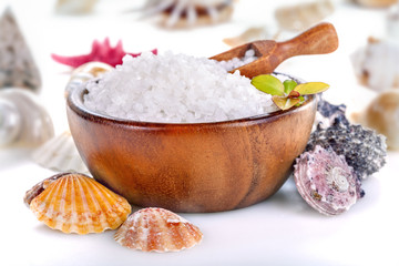 Fototapeta na wymiar Sea bath salt in bowl and .sea shells on white background