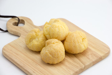 Choux cream on wooden plate 