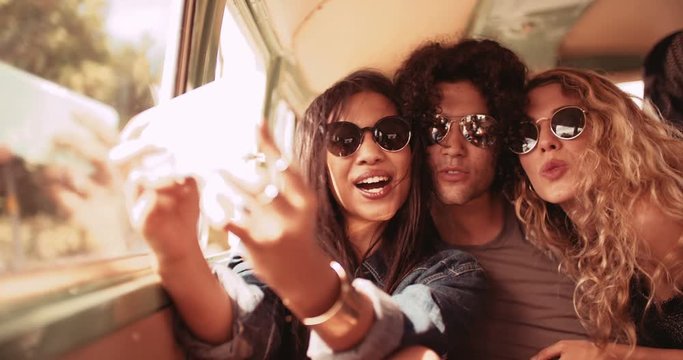 Multi-Ethnic Hipster Group in Retro Van Taking Road trip Selfie