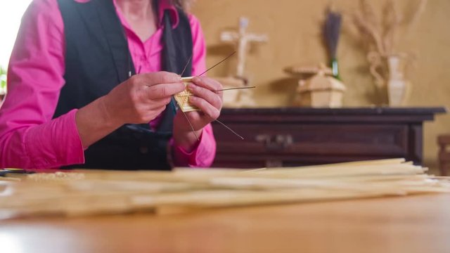 Old person hands crafting from straw