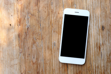 Smartphone on wooden background