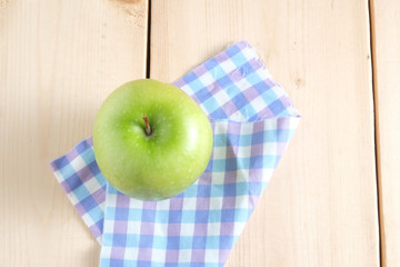 Green apple on a wooden table