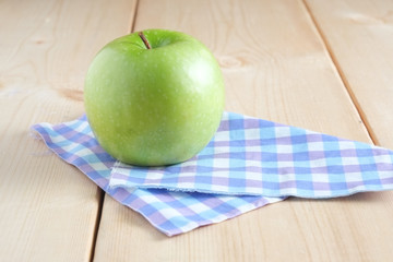 Green apple on a wooden table
