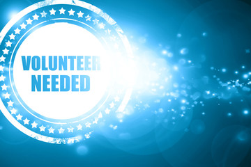 Blue stamp on a glittering background: volunteer needed