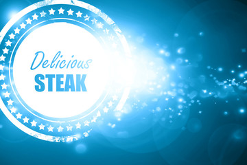 Blue stamp on a glittering background: Delicious steak sign