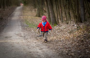 Fototapeta premium Happy caucasian boy playing outdoor in forest