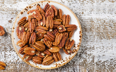 Pecans  on a wooden table.