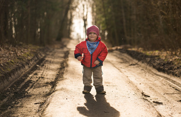 Happy caucasian boy playing outdoor in forest