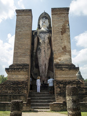 Standing Buddha statue, historical ruins of Sukhotai, Thailand