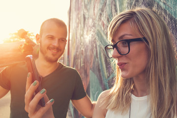 Urban couple doing selfie outdoors.