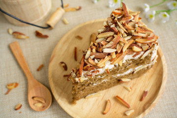 Coffee cake with almonds on top and cup of tea