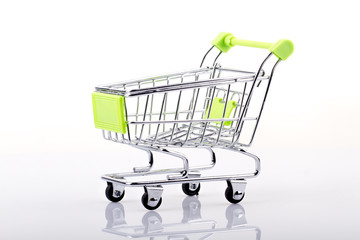 A green Shopping Cart Isolated On White reflection