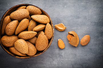Group of almond nuts with leaves.Wooden background.
