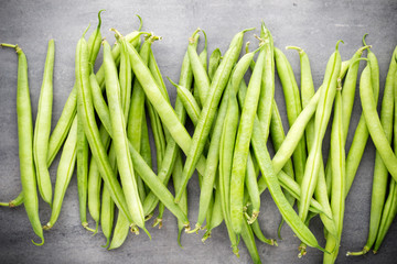 Green beans  on a gray background.