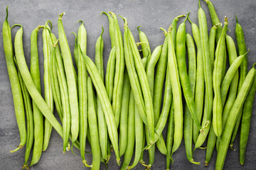 Green beans  on a gray background.