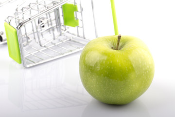 Shopping Cart with Green Organic Apple on white background
