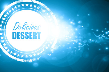Blue stamp on a glittering background: Delicious dessert sign
