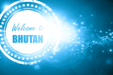 Blue stamp on a glittering background: Welcome to bhutan