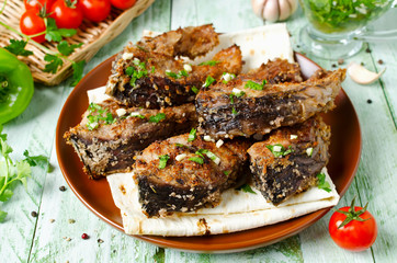 Steaks of carp in bread crumbs and spices