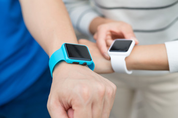 Two people using smart watch together