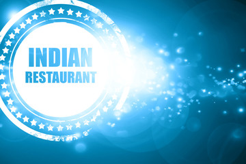 Blue stamp on a glittering background: Delicious indian restaura