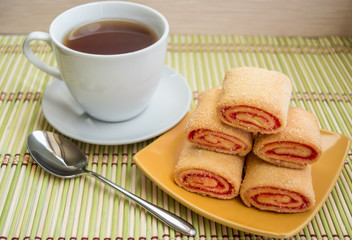 Cookies from puff pastry with raspberry jam on a plate