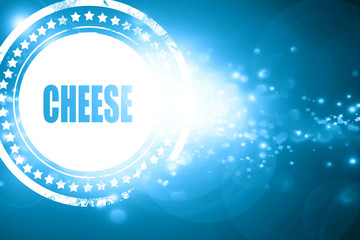 Blue stamp on a glittering background: Delicious cheese sign