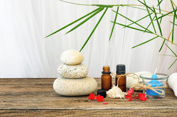 Spa still life with candle,zen stone and essential oil on wooden table