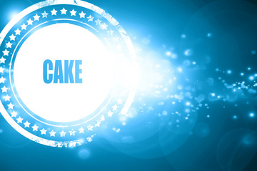 Blue stamp on a glittering background: Delicious cake sign