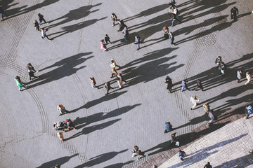 People with lolg shadows, top view.