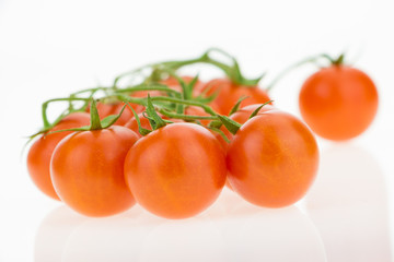 Heap of cherry tomatoes, on white background.