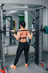 Fototapeta premium The girl goes in for sports in the gym