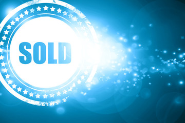 Blue stamp on a glittering background: sold sign background