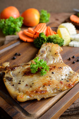 Kurobuta pork chop steak on wooden table