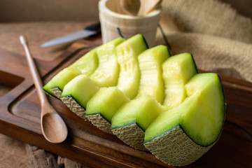 Juicy slice melon on a wooden table