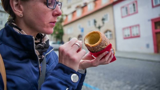 Tourist eat hot sweet dessert Trdelnik