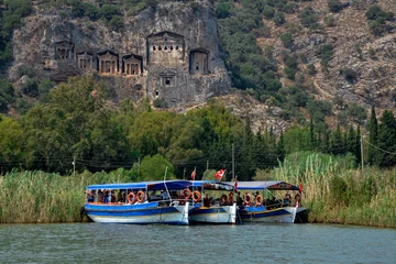 Poster turkish tourist boats on Dalyan Cayi river with ancient Lycian rock tombs cut in cliffs   Dalyan, Turkey © ssmalomuzh