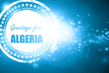 Blue stamp on a glittering background: Greetings from algeria