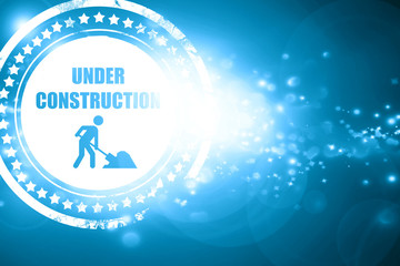 Blue stamp on a glittering background: Under construction sign
