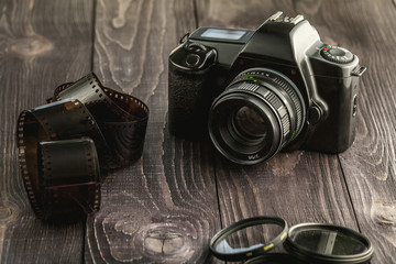 Photo camera on wooden rustic background