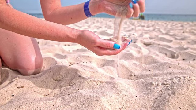 Slipping sand through person hands
