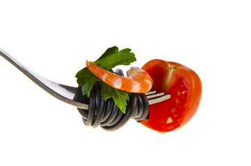 pasta on a fork with shrimp tomato and parsley on a white background