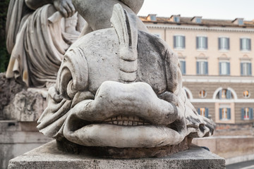 Fototapeta na wymiar Ancient dolphin sculpture on Piazza del Popolo