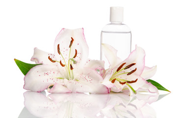 tonic for skin care with lily flowers on a white background