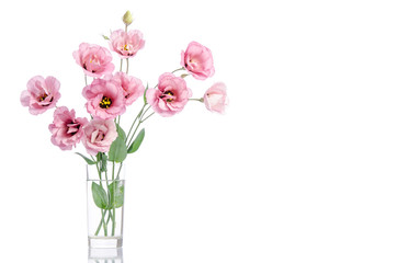 bunch of pink eustoma flowers in glass vase isolated on white