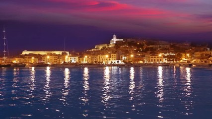 Ibiza Eivissa town sunset with city lights reflection in Mediterranean sea of balearic Islands of Spain
