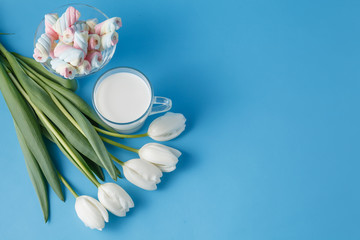 Fototapeta na wymiar White tulips with twisted marshmalow