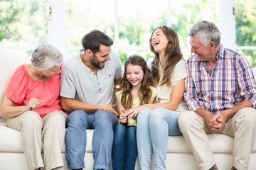 Cheerful family sitting on sofa